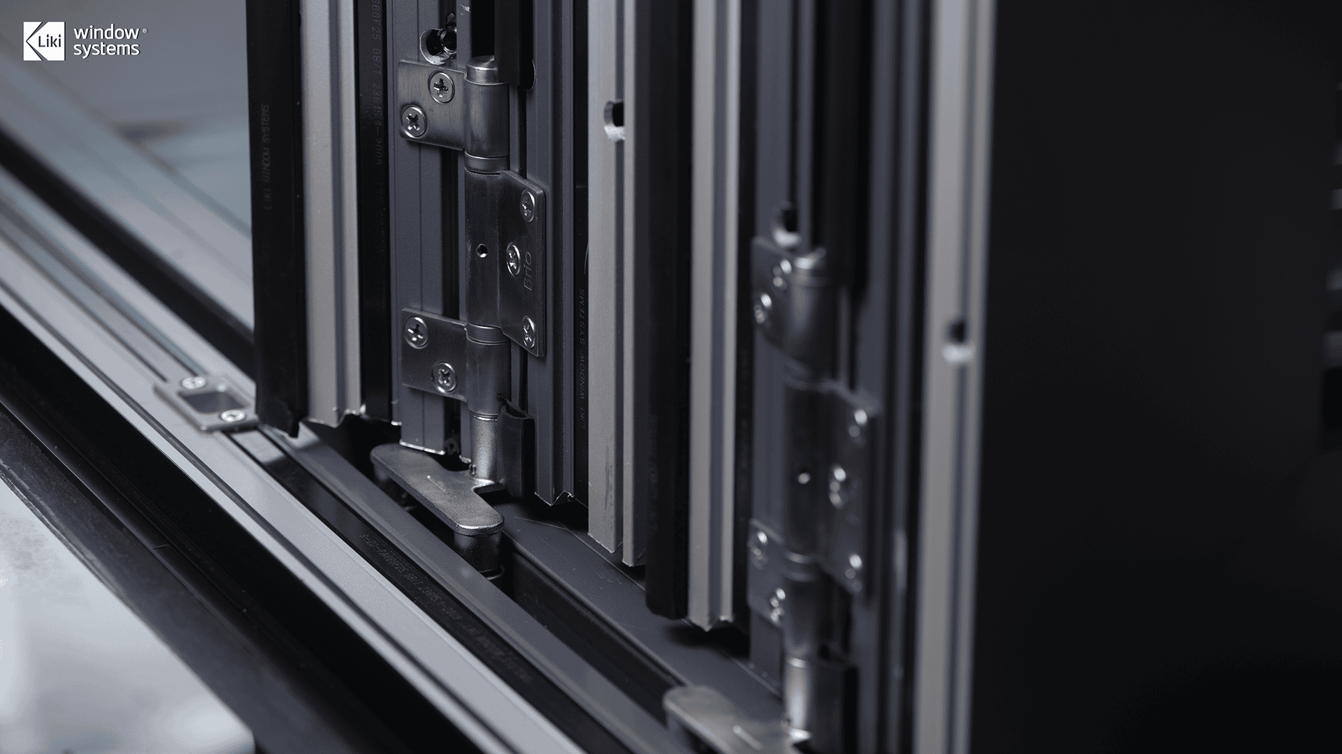 Close-up of LIKI aluminum folding door system featuring genuine Brio architectural hinges and tracks for smooth, heavy-duty operation.